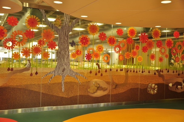 The bottom of the mural is opaque, so children in the program room aren't distracted; the top is transparent, so parents can check in on their child.